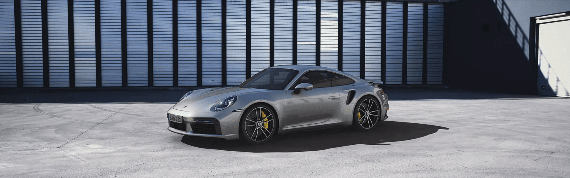 2025 Porsche 911 Turbo in grey parking with side view and front view-Banner